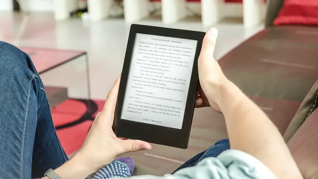 A compact e-reader held in a reader's hand