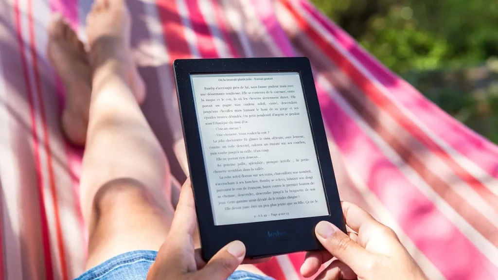 Person reading an e-reader while relaxing