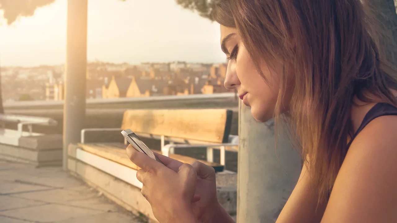 Person texting on a smartphone with an AI assistant