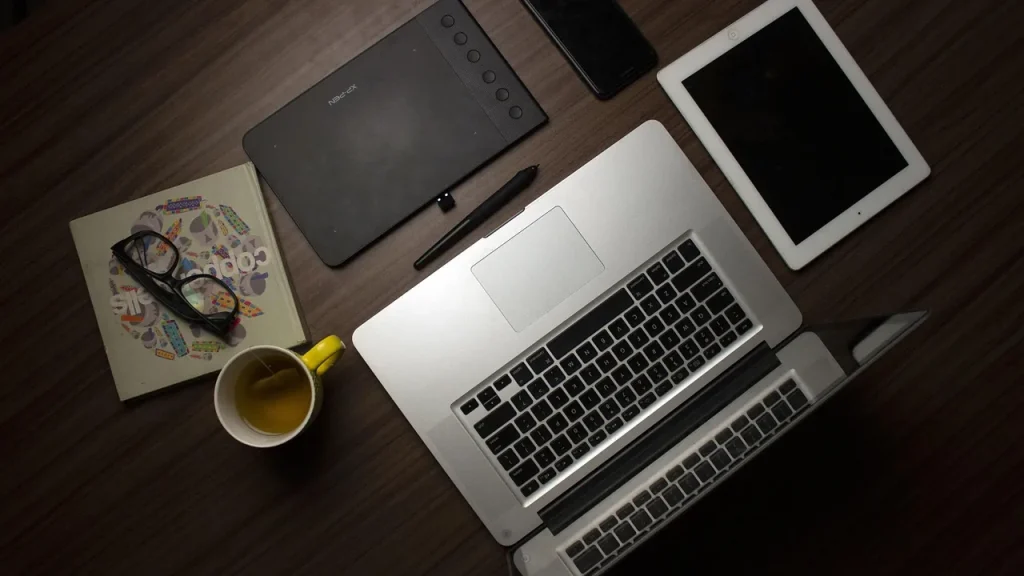 A design studio desk with sketches and a digital tablet