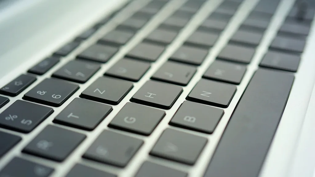 Close-up of hands typing on a keyboard