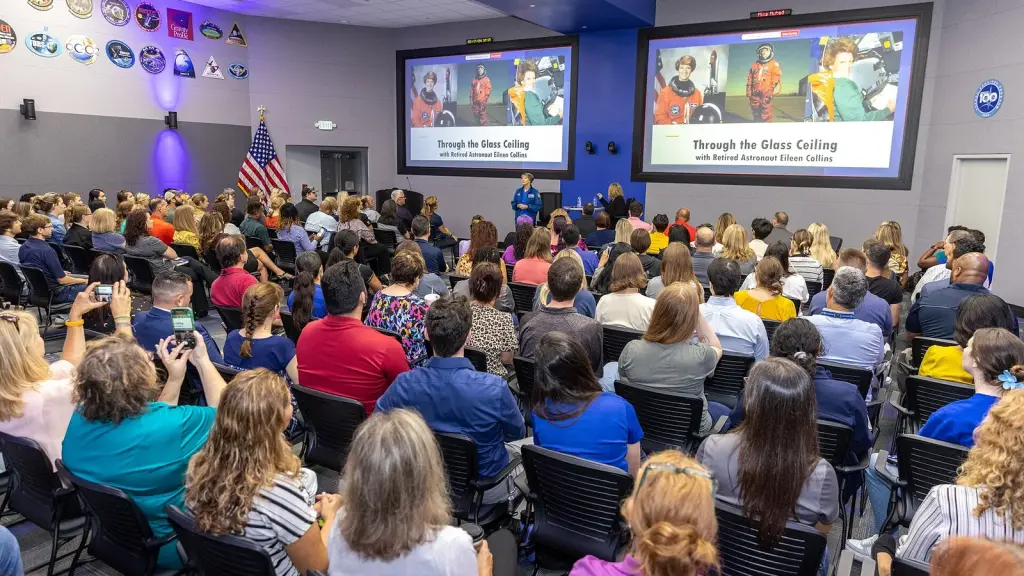 Astronauts at a postflight press conference in a NASA briefing room