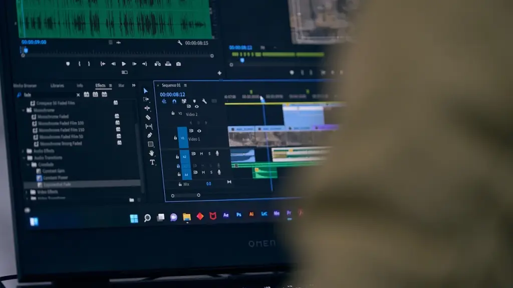 Laptop screen showing video editing timeline and color tools