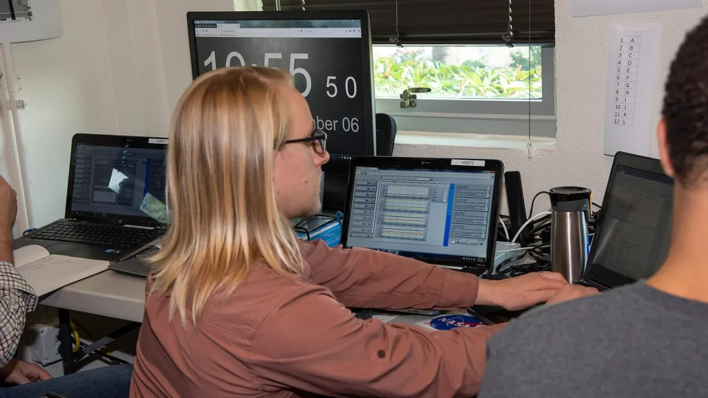 Researchers collaborating over AI safety simulations in a lab