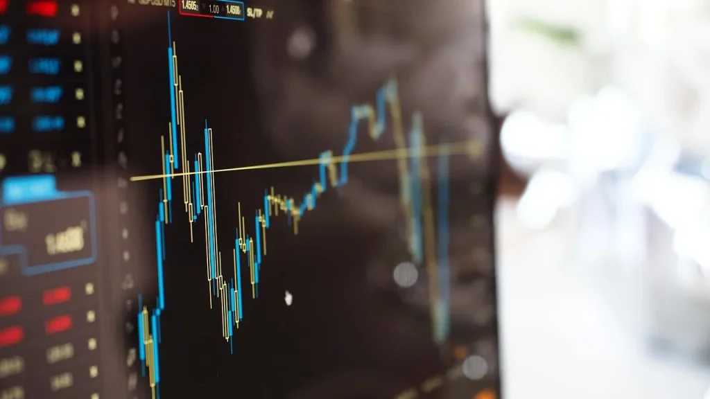 Stock market and financial charts on a screen in a trading room