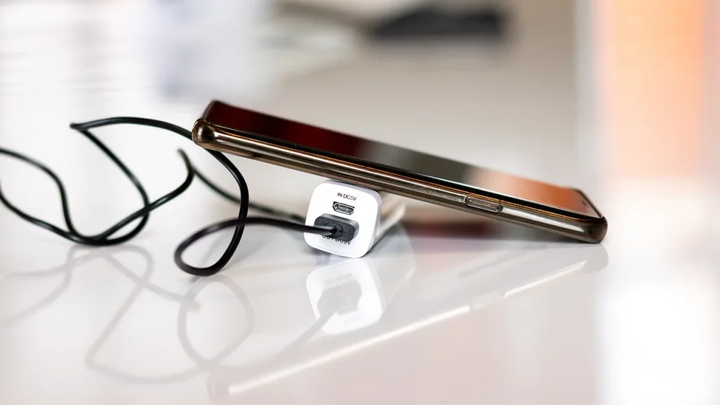 Fast charging cable plugged into a large battery phone