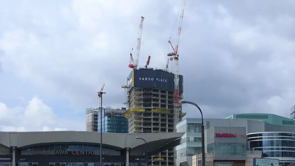 The Varso tower under construction or completed near an older building
