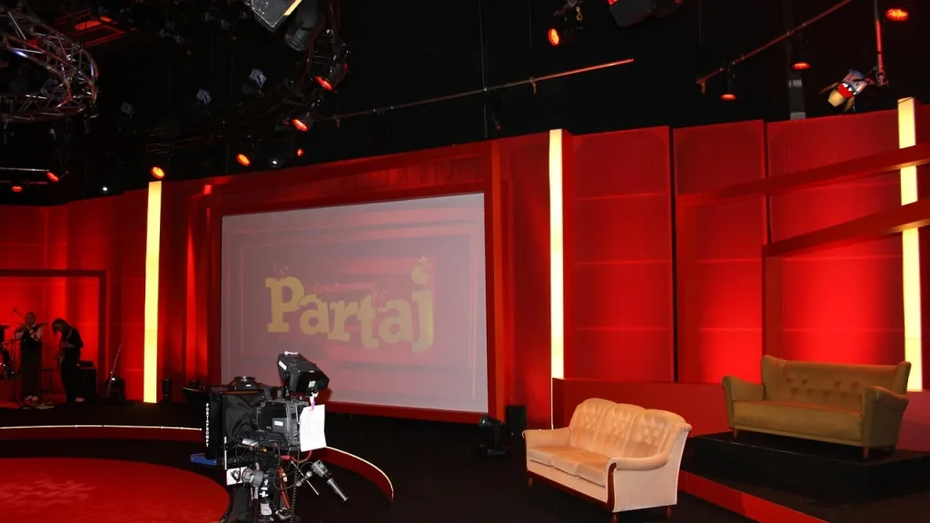 TV production set with actors and phones on a desk