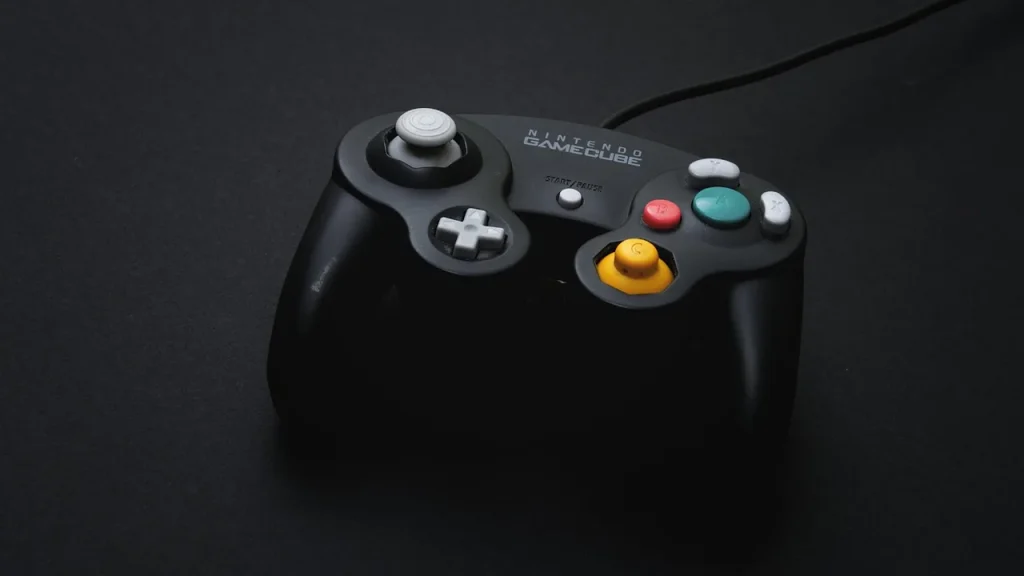 A close-up of a game controller resting on a desk