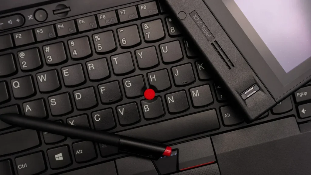 Tablet with stylus lying on a wooden table
