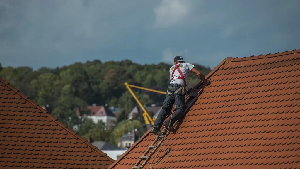 Roofers and electricians coordinating on a tile solar roof project
