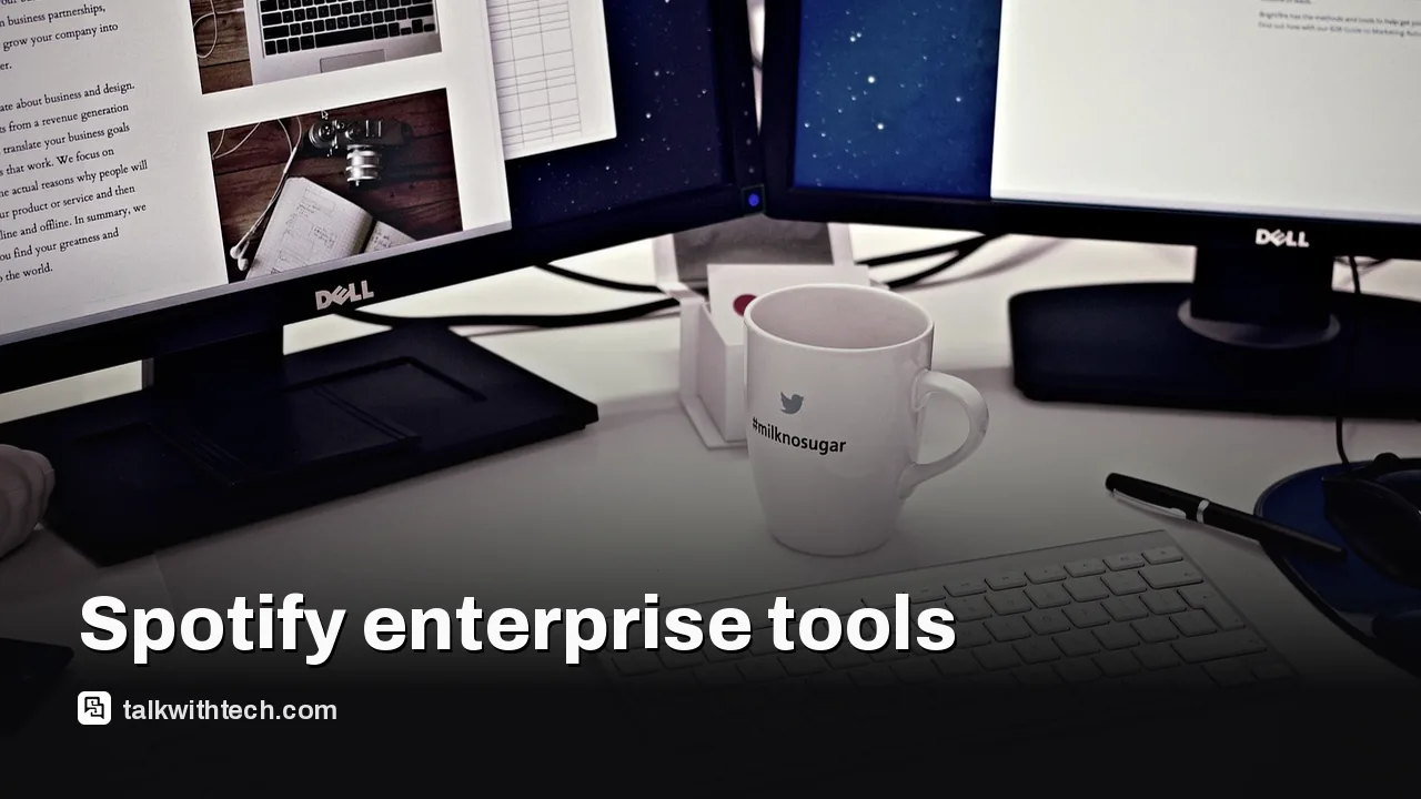 A modern office desk with multiple monitors and work tools