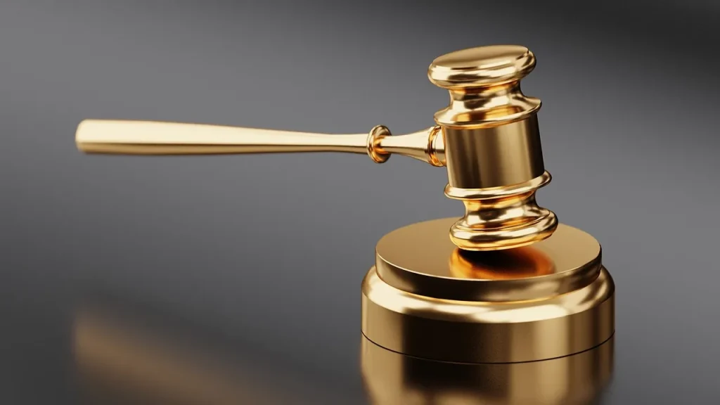 Court documents and a gavel on a wooden table