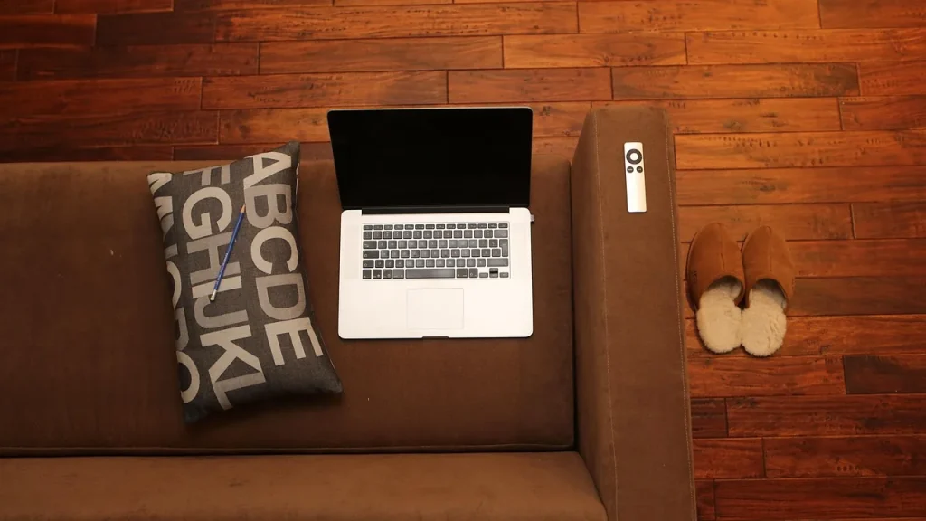 Apple TV box and remote on a entertainment shelf
