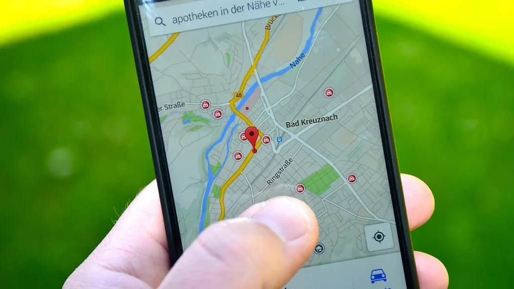 Close-up of a phone showing a map with a home pin