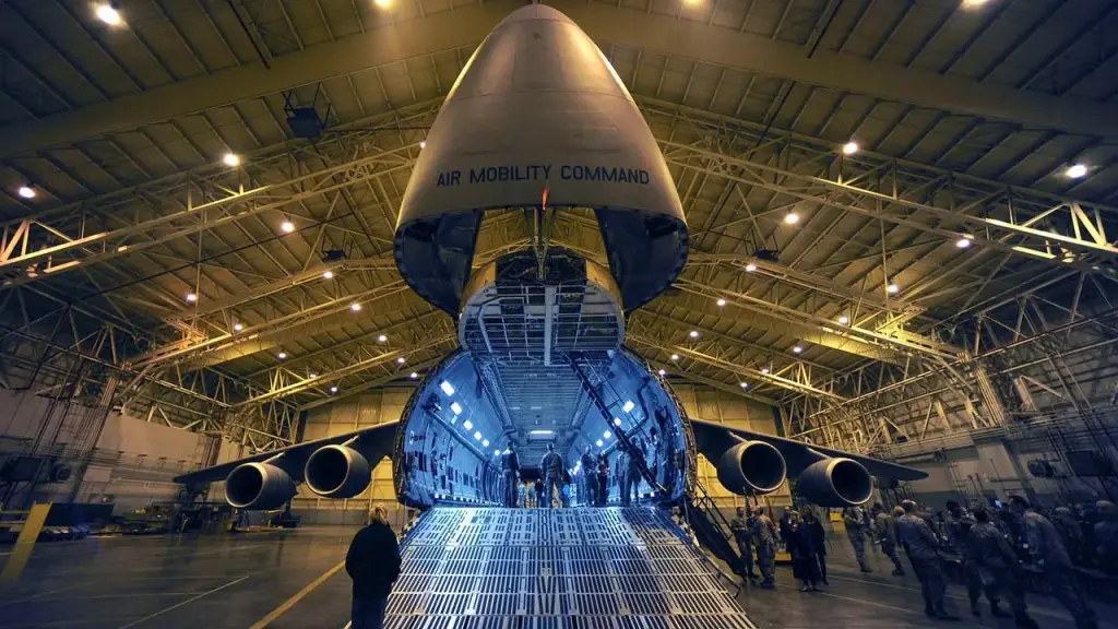 Air Force base hangar with aircraft and technicians