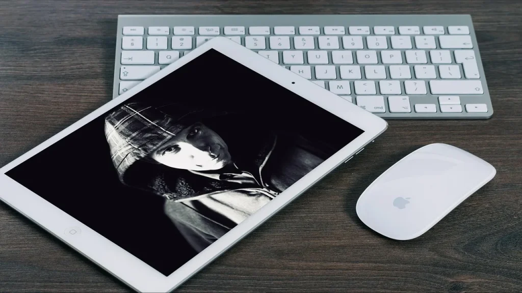 Tablet and TV remote next to a streaming service logo