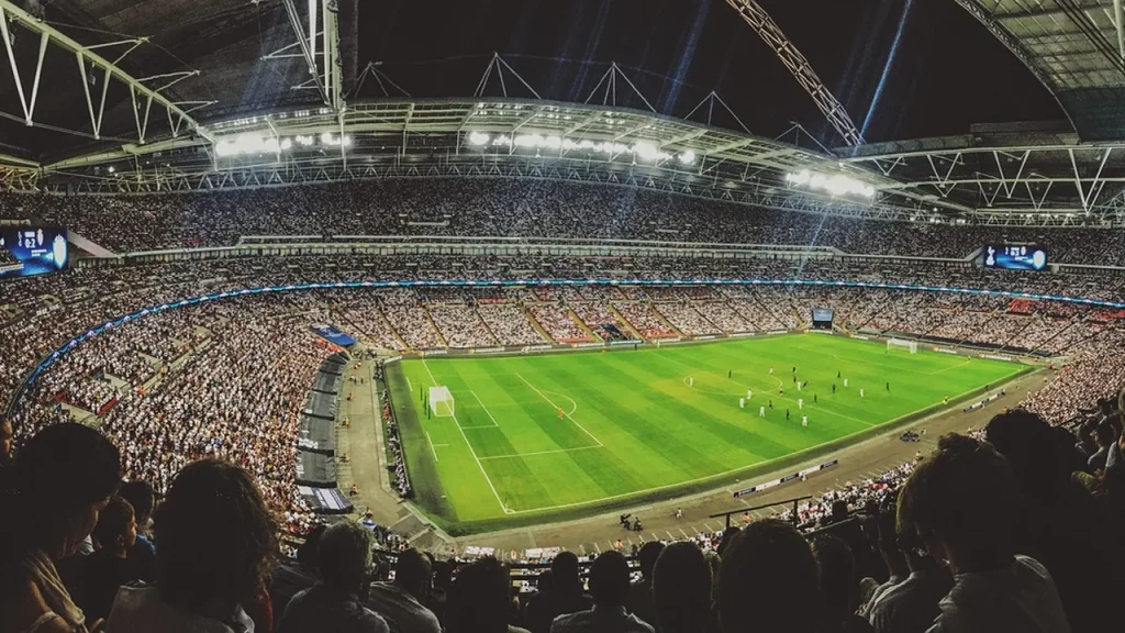 Crowd in a stadium cheering during a rugby match