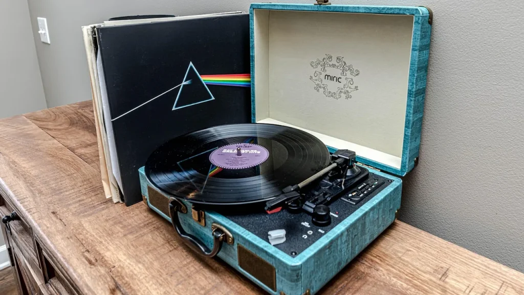 A collection of vinyl records near a turntable