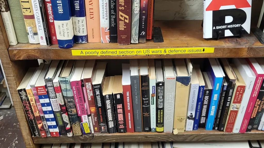 Warm bookstore shelves packed with books and staff