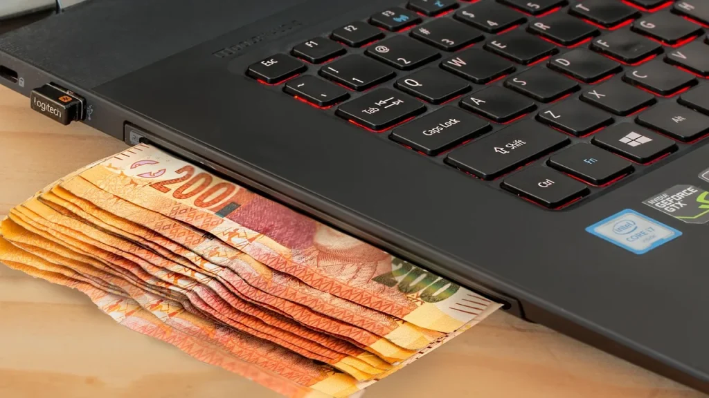 Person on a laptop with a payment app open on screen